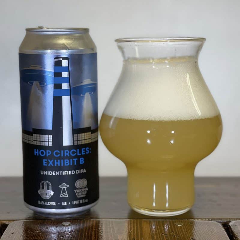 Can of BlackStack Brewing Hop Circles: Exhibit B sitting next to a glass filled with the beer.