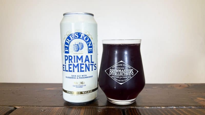 Can of Firestone Walker Primal Elements: Blueberry & Marionberry next to a full glass of beer.