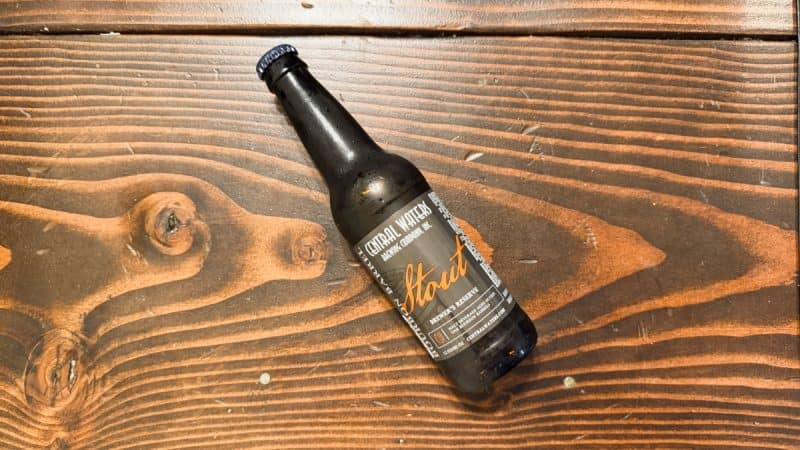 Bottle of Central Waters Brewing Brewer’s Reserve Bourbon Barrel Stout 2025 laying on a wood table.