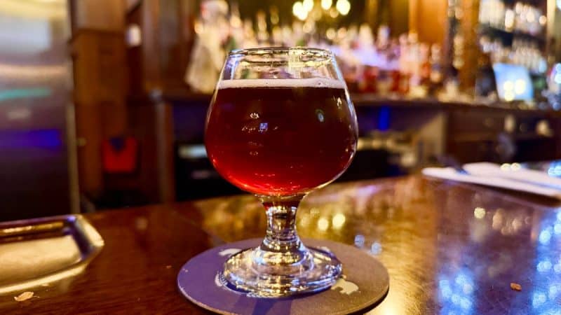 Glass of Town Hall Brewery Iced Old Vine Cruvee sitting on the bar.